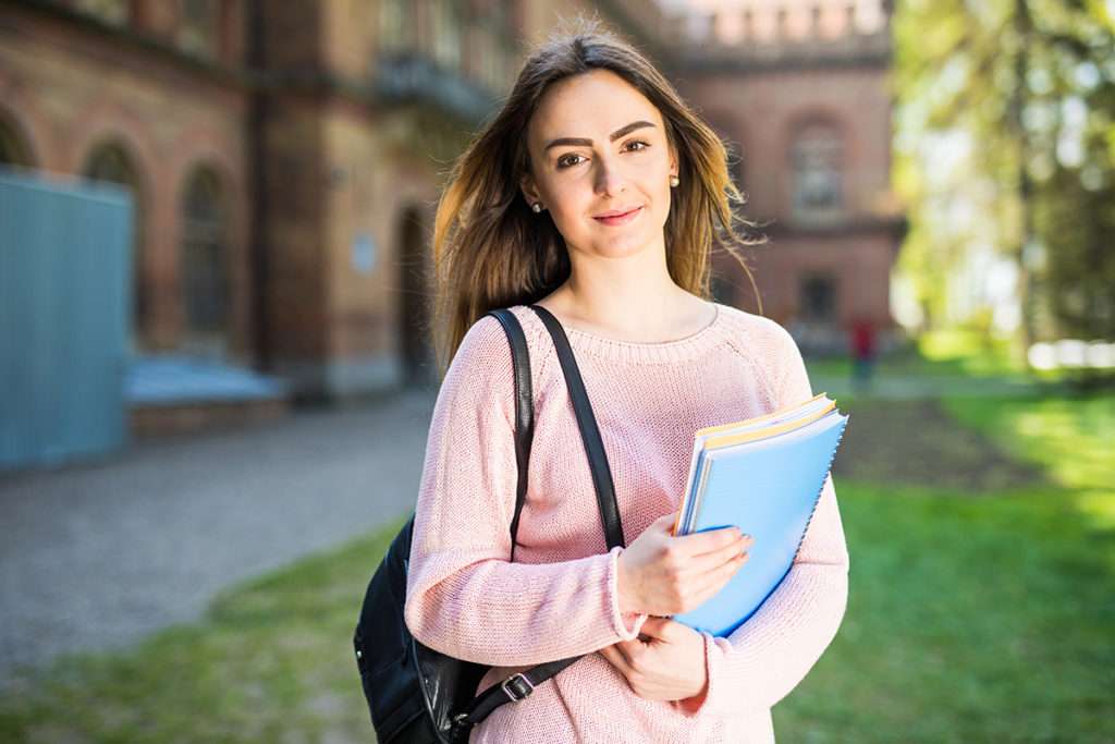 university-student-girl-looking-happy-smiling-with-book-or-notebook-in